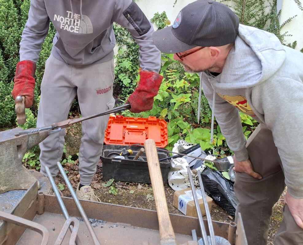 Young person forging metal